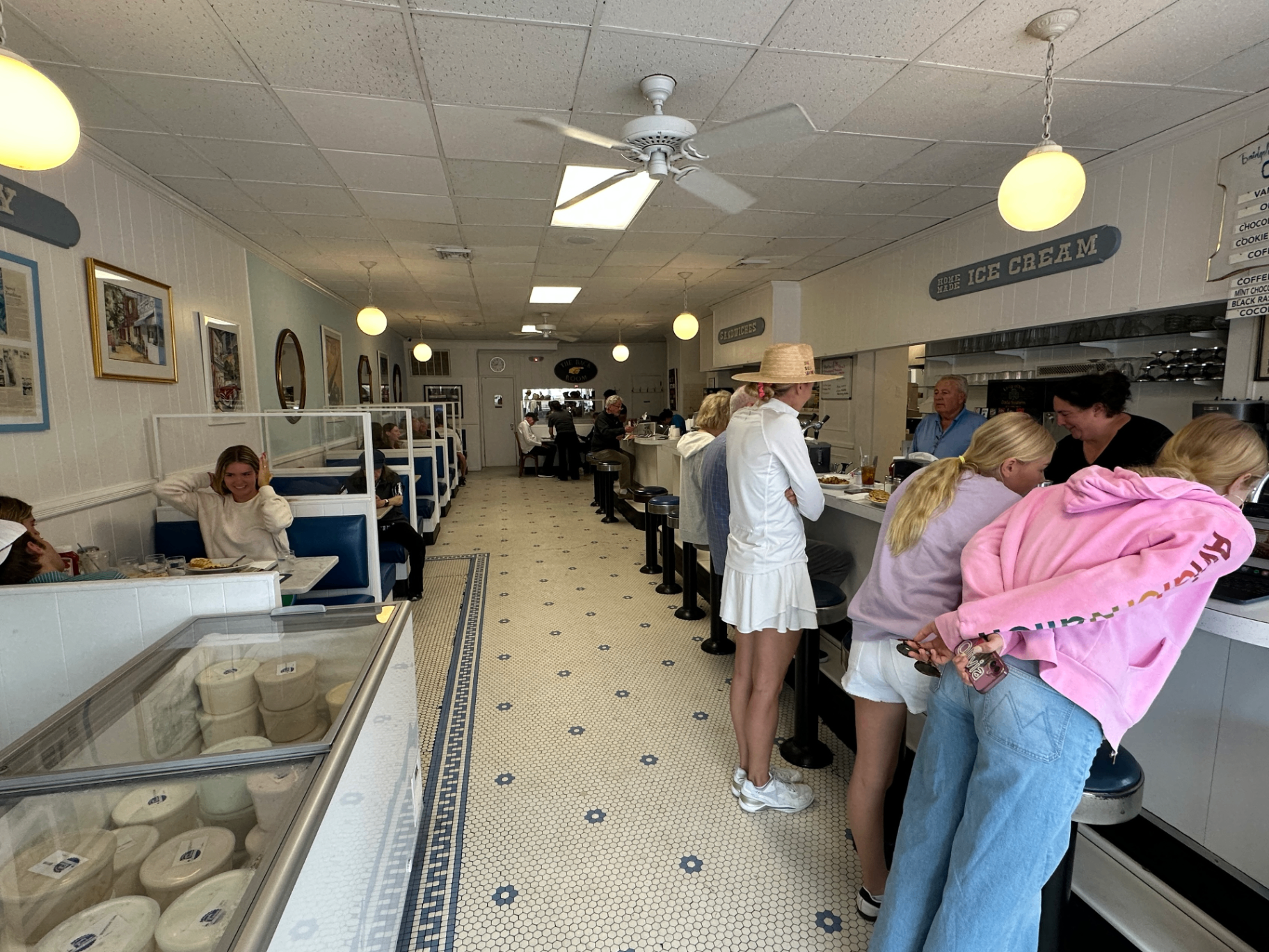 Candy Kitchen dining room with booths, counter stools, and ice cream freezer